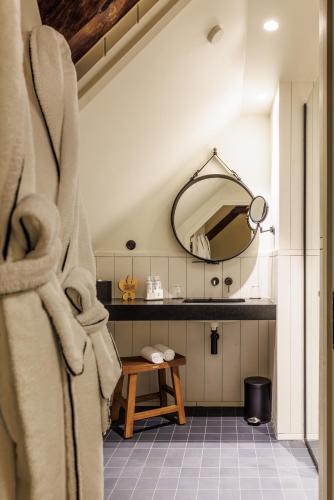 a bathroom with a sink and a mirror at Domaine de Locguénolé & Spa - Relais & Chateaux in Kervignac