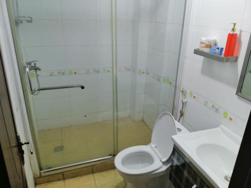 a bathroom with a shower and a toilet and a sink at Mariana Shared Home in Dar es Salaam