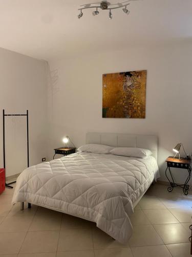 a bedroom with a bed and a painting on the wall at La perla del mare in Trapani