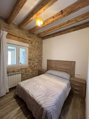 a bedroom with a large bed and a window at Casa Rural La Atalaya in Montarrón