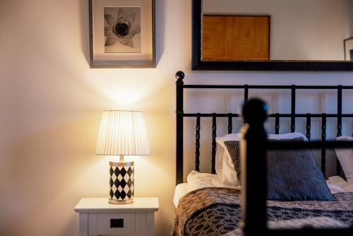 a bedroom with a bed and a lamp on a table at Art House Ars Vivendi in Rīga