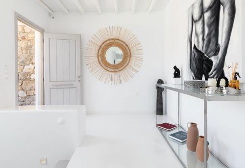 a white room with a mirror on the wall at Villa Elia Breeze Mykonos in Mikonos