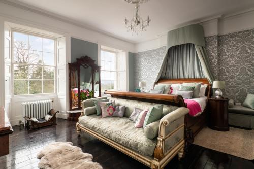 a living room with a couch and a bed at Plas Llangoedmor in Cardigan