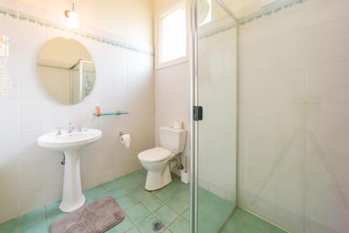 a bathroom with a toilet and a sink and a shower at East Sydney Hotel in Sydney