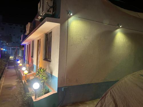 a row of lights on a building at night at Tapama Resort Bakkhali in Bakkhali