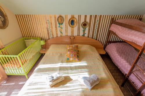 a small bedroom with a bed and two bunk beds at Vikendica Životić in Zlatibor