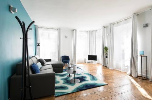 ein Wohnzimmer mit einem Sofa und einem Teppich in der Unterkunft 123paris city in Paris