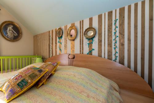 a bedroom with a wooden bed and clocks on the wall at Vikendica Životić in Zlatibor