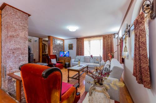 a living room with a couch and a table at Vikendica Životić in Zlatibor