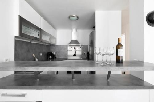 a kitchen with a table with wine glasses on it at 123paris city in Paris