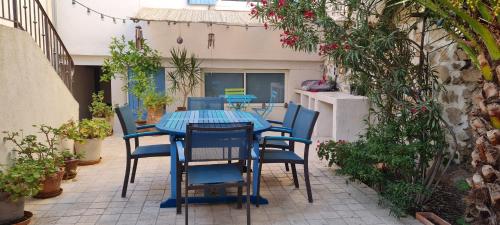 une table et des chaises bleues sur une terrasse dans l'établissement Un havre de paix à l'Estaque Marseille, à Marseille