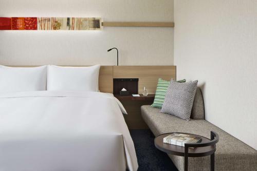 a hotel room with a bed and a couch at Hyatt House Kanazawa in Kanazawa