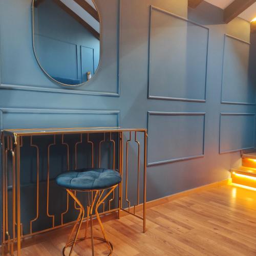a stool in a room with a mirror at L Suites The Writer's House in Gythio