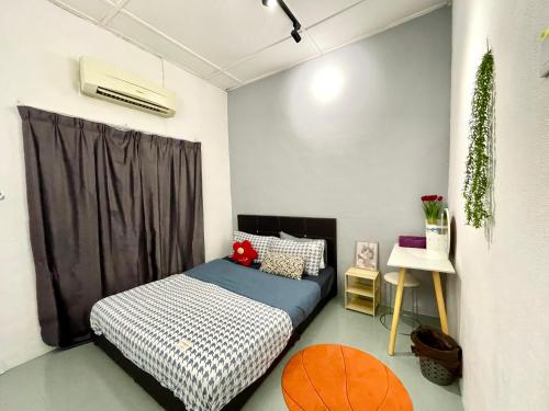 a small bedroom with a bed and a window at Heritage Cozy Entire 3 Bedroom House At Kijang Alma Bukit Mertajam in Bukit Mertajam