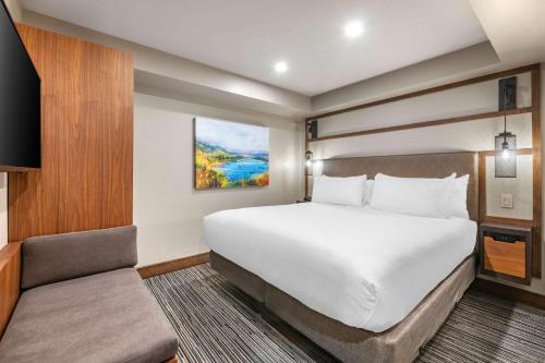 a hotel room with a bed and a chair at Hilton Vacation Club Tahoe Seasons Lake Tahoe in South Lake Tahoe