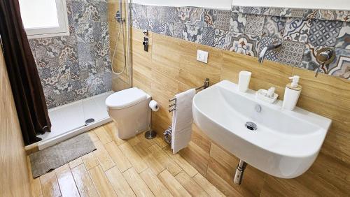 a bathroom with a sink and a toilet at Stabile Hospitality in Trapani