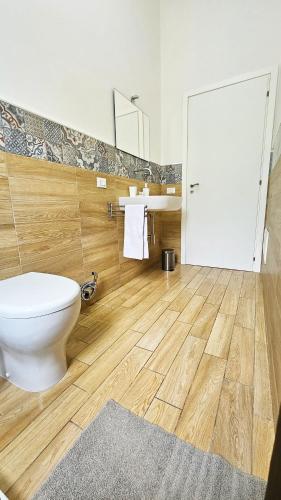 a bathroom with a toilet and a sink and a mirror at Stabile Hospitality in Trapani