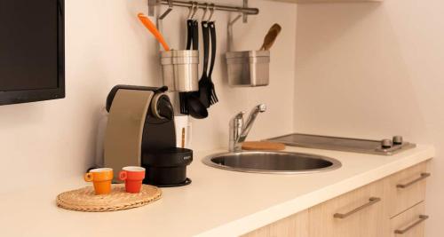 a kitchen counter top with a sink and a kitchen counter sidx sidx sidx at Russomanno Apartments in Como