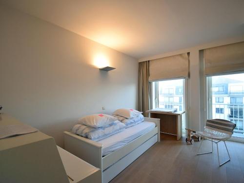 a bedroom with a bed and a window at Golden beach 0203 with sea-view in De Haan in De Haan