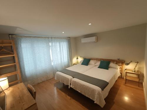 a bedroom with a large bed and a window at Centro ciudad in Seville