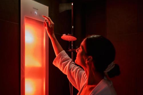 a woman standing in front of an open refrigerator at Captains Boathouse in Harderwijk