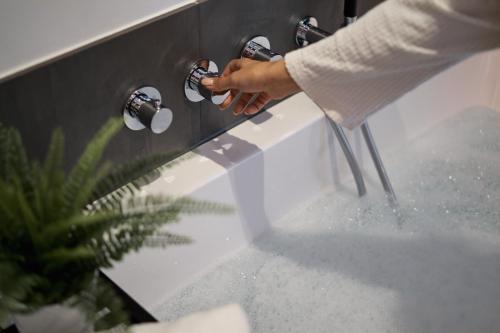 a person is drinking water from a sink at Captains Boathouse in Harderwijk