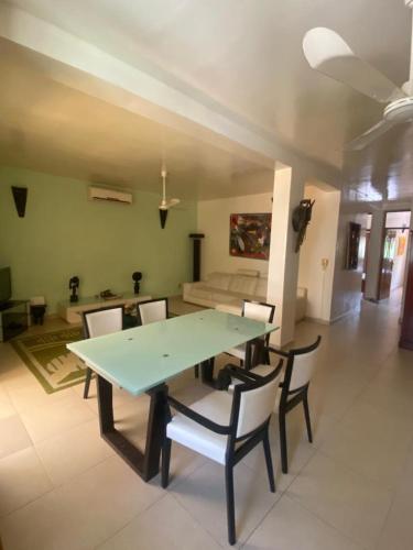 a living room with a green table and chairs at Amina Haus in Sali Poulang