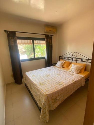 a bedroom with a large bed with a window at Amina Haus in Sali Poulang