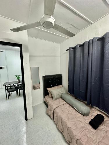 a living room with a couch and a ceiling fan at Homestay Syahezzie fully aircond Netflix With Jacuzi in Ampang