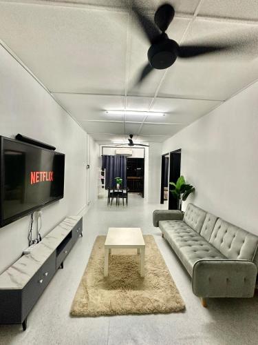 a living room with a couch and a tv at Homestay Syahezzie fully aircond Netflix With Jacuzi in Ampang