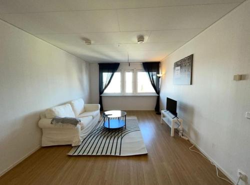 a living room with a couch and a table at Rentalux Apartments in Örnsköldsvik in Örnsköldsvik