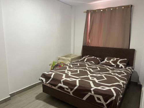 a bedroom with a bed with a black and white comforter at CaSa PrivaDa con Piscina in Playas