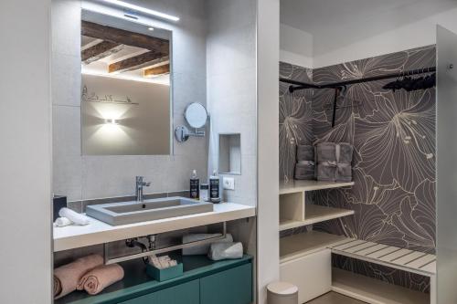 a bathroom with a sink and a mirror at Maison Valentina in Merano