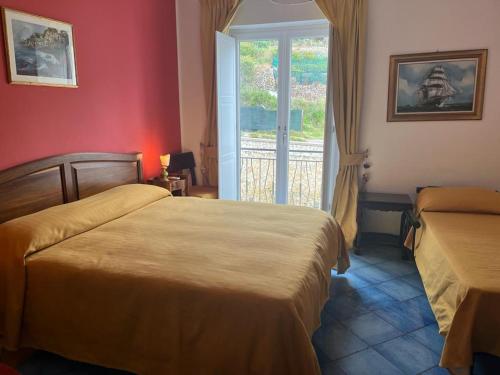 a hotel room with two beds and a window at Lunaponzese-Ponza centro in Ponza