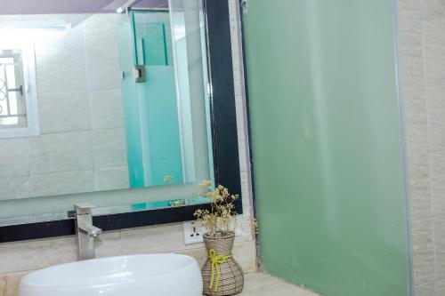 a bathroom with a sink and a mirror at Ìtùnú at Molara's Villa in Abeokuta