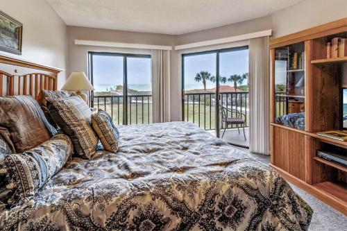 a bedroom with a bed and a balcony at Land's End 9-204 Beach Front in St Pete Beach