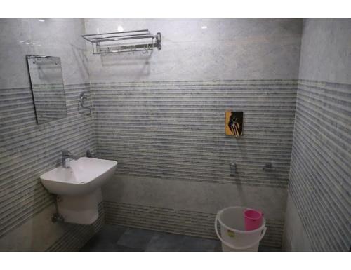 a bathroom with a sink and a toilet at Hotel Ess Pee 91, Chandigarh in Chandīgarh