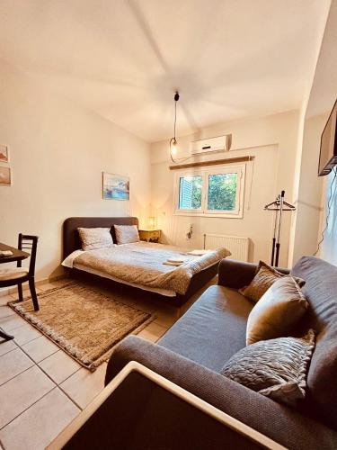 uma sala de estar com duas camas e um sofá em George Apartment em Lamía