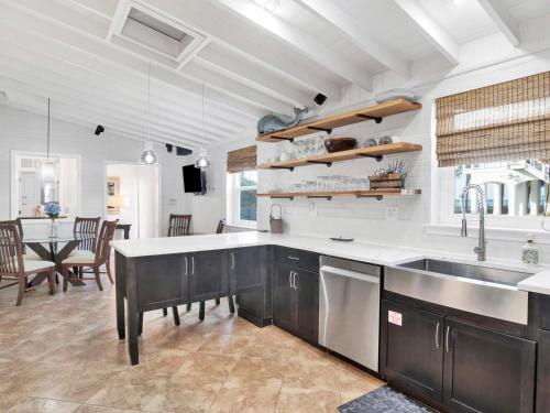 a kitchen with a large sink and a table at Playa Panferio in Pensacola Beach