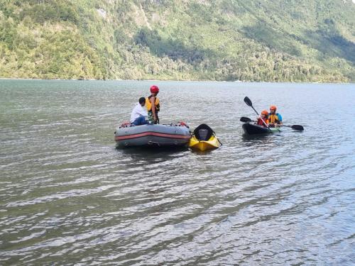 a group of people in a raft in the water at Puerta austral in Puelo