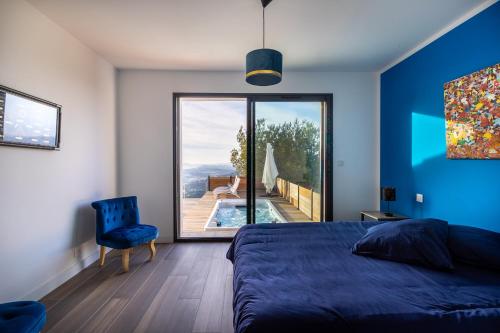a bedroom with a bed and a view of a pool at Villa 4 Etoiles vue sur les Iles d'Or Carqueiranne Sea and Mountain Pleasure Villa vue mer 180 in Carqueiranne