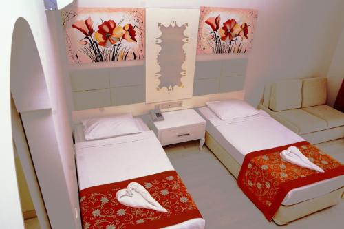 a small room with two beds and a couch at MIRAMOR HOTEL & Spa - ULTRA ALL INCLUSIVE SELECTION in Kemer