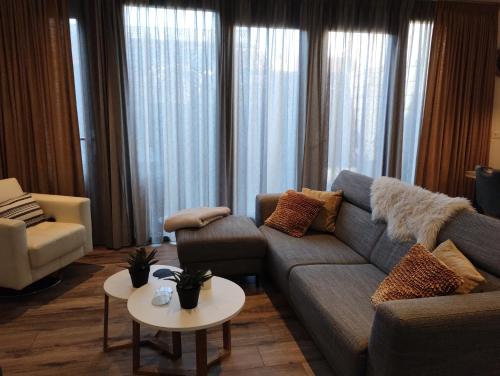 a living room with a couch and a table at Aan't Strand Bed by the Sea Adults only in Westkapelle