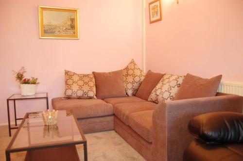a living room with a couch and a table at Wulfrun in Tywyn
