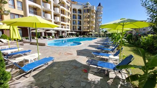 a group of chairs and umbrellas next to a pool at Diamond Palace in Sunny Beach