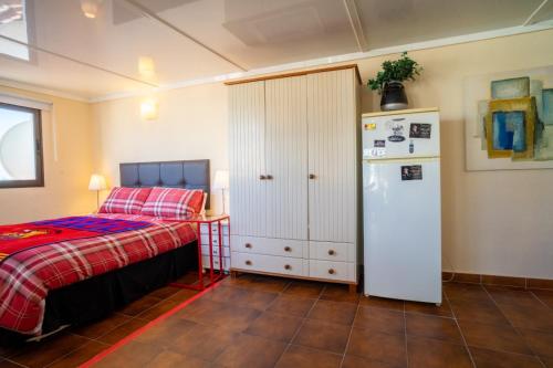 a bedroom with a bed and a refrigerator at Villa Jazmin in Fuengirola