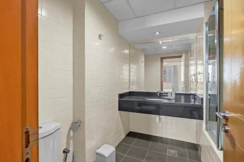 a bathroom with a sink and a toilet at Modern living nestled with 1BR_Silicon Oasis Dubai in Dubai