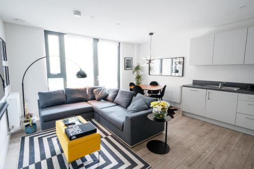 een woonkamer met een bank en een tafel bij Beautiful & Contemporary Hackney Retreat in Londen