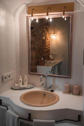 a bathroom with a sink with a large mirror at ES CUCONS RURAL HOTEL in San Antonio