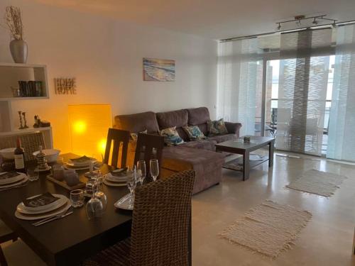 a living room with a couch and a dining table at Residencia Lucia in Manilva